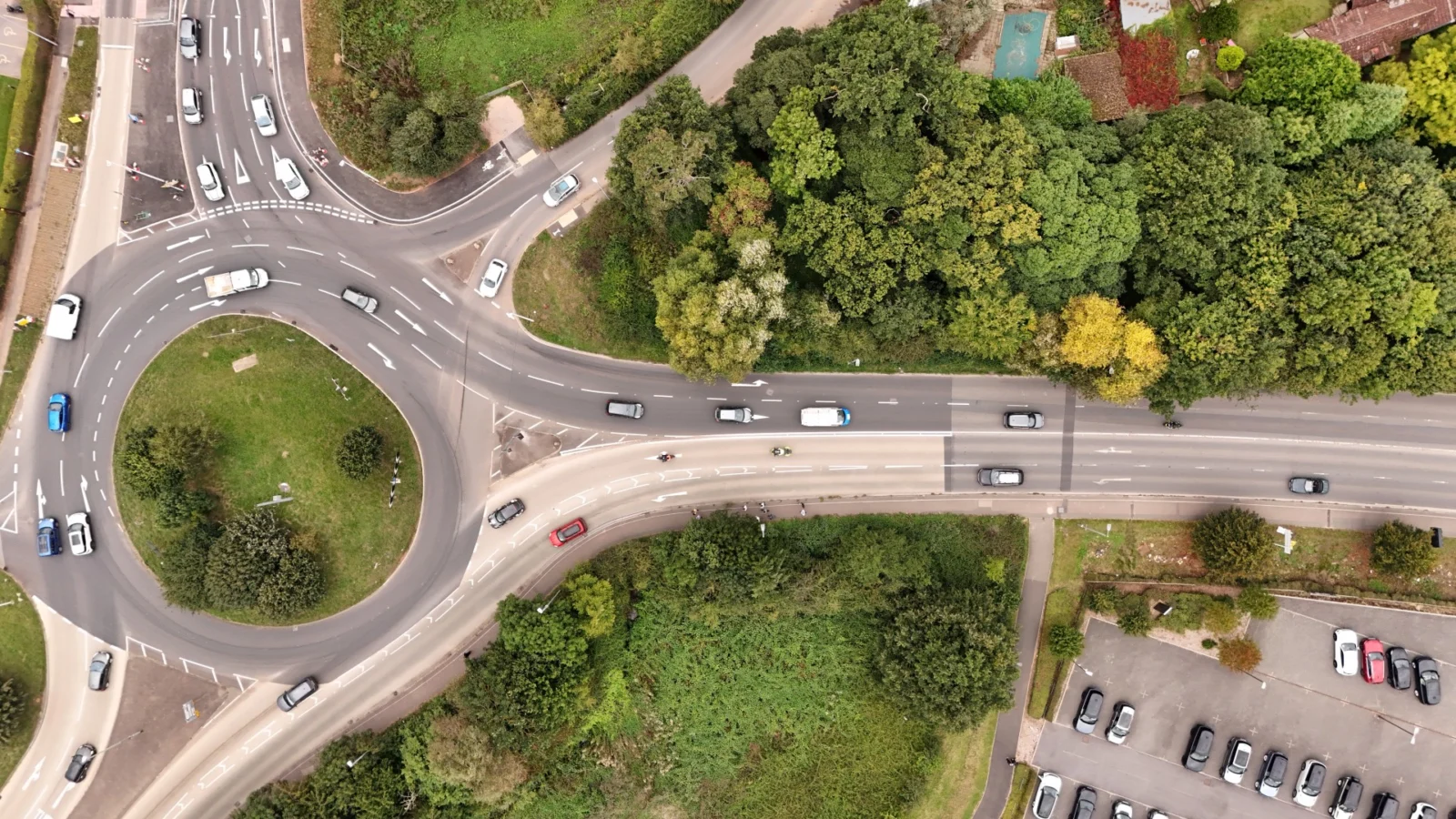 Aerial view of a roundabout, traffic lanes, connecting roads and surrounding trees