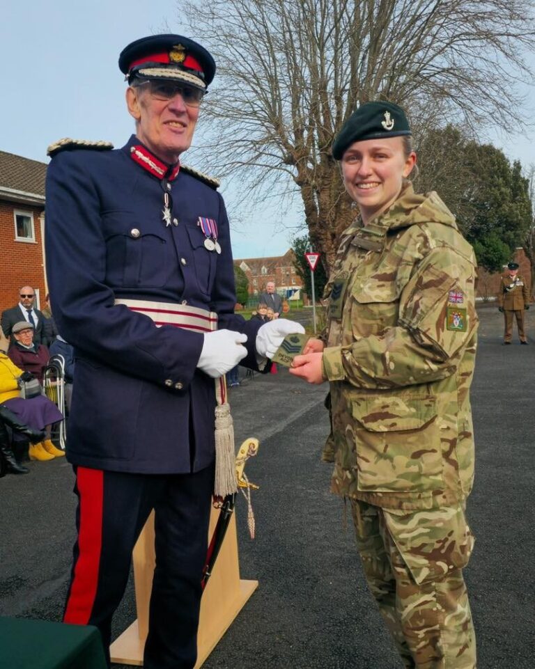 KW, from the Bridge Civil Engineering team, in cadet uniform receiving a promotion to Colour Sergeant from an officer in ceremonial dress