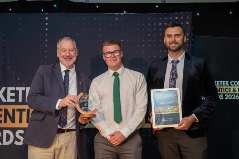 Three men on stage at the 2026 apprentice awards with a framed certificate and trophy, celebrating a Bridge Civil Engineering apprentice